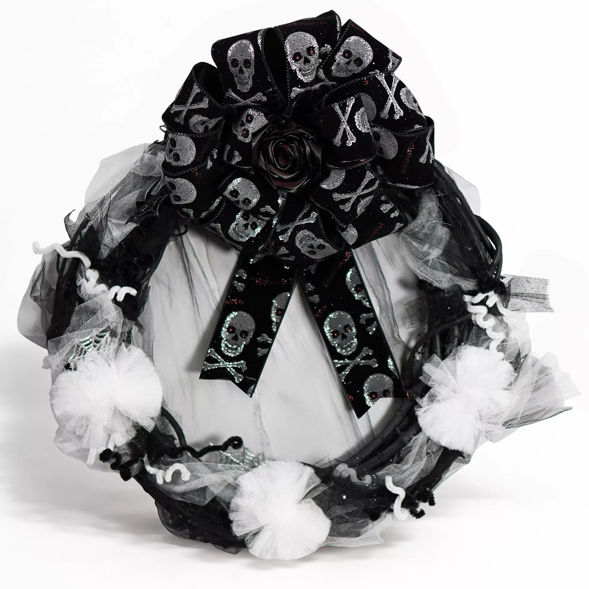 Corona negra con moño de listón estampado de calaveras, tul blanco y negro y limpiapipas